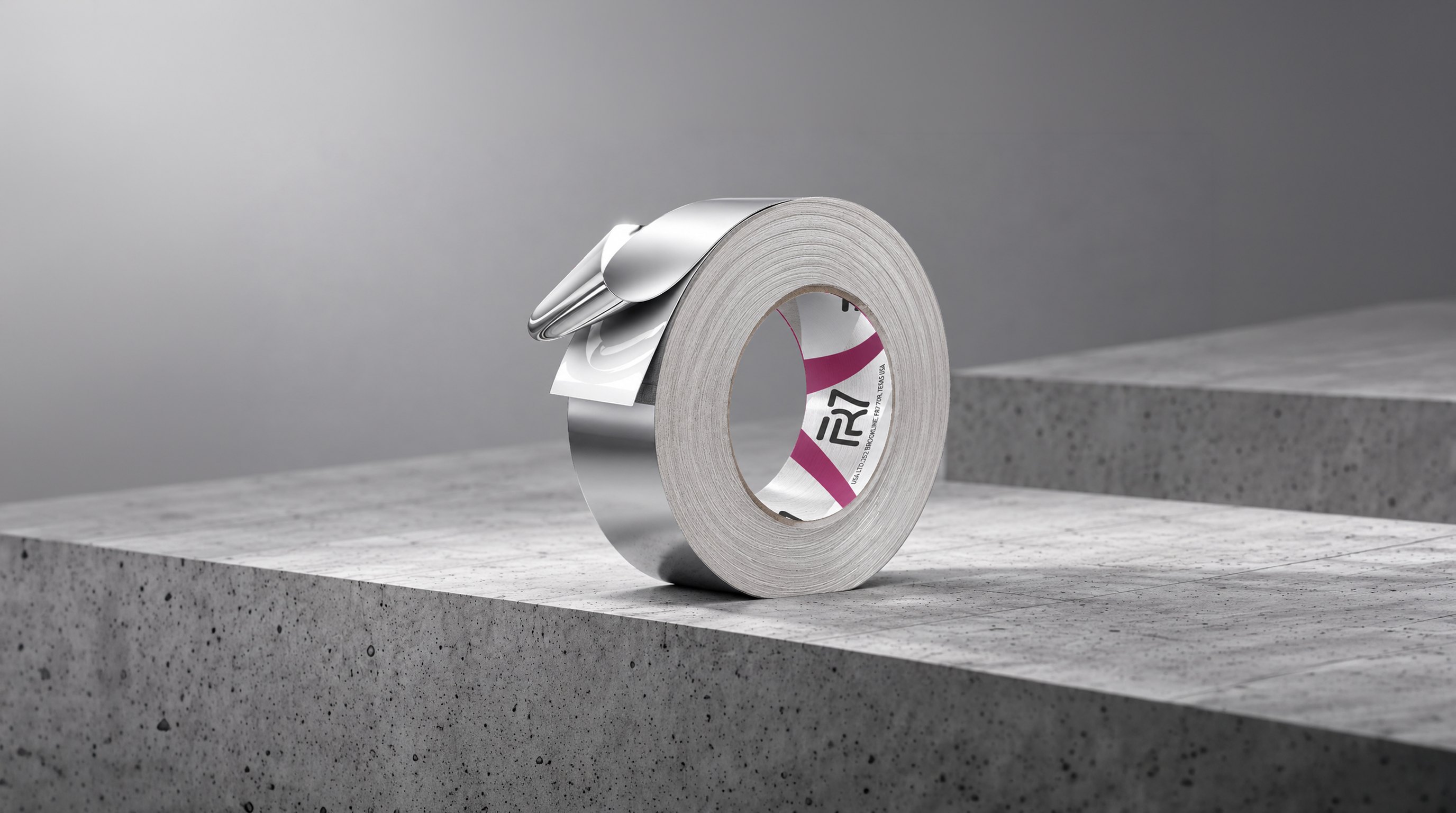 FR7 aluminium foil tape roll with its end peeled back, on concrete